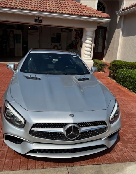 Silver Mercedes convertible detailed in a customer's driveway