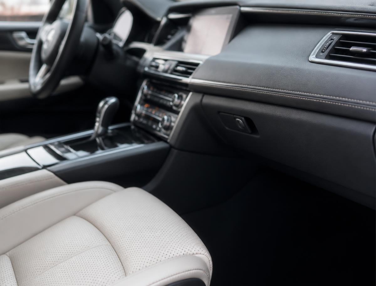 Freshly detailed car interior with clean leather seats and dashboard
